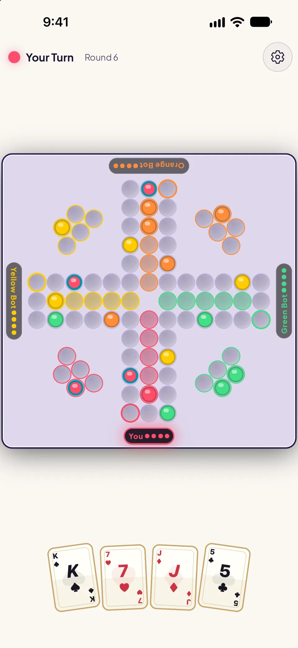 Back Up game board in round 6 of a 4-player match. A cross-shaped track of marble slots with colored home bases in each corner and colored safe-zone lanes leading to the center, seat labels for You, Yellow Bot, Orange Bot and Green Bot, and the player’s hand of four cards below: King, 7, Jack and 5.