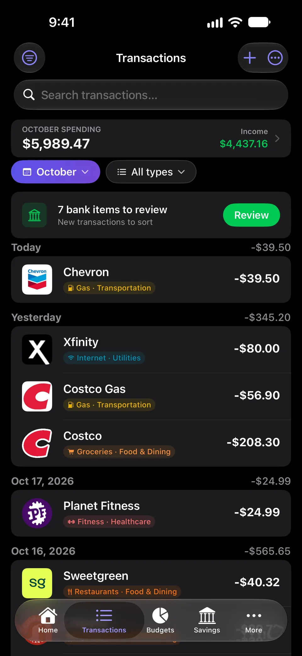 Transactions feed with October spending and income totals, a banner for 7 bank items waiting for review, and transactions grouped by day, each with a merchant logo and a colored category tag.